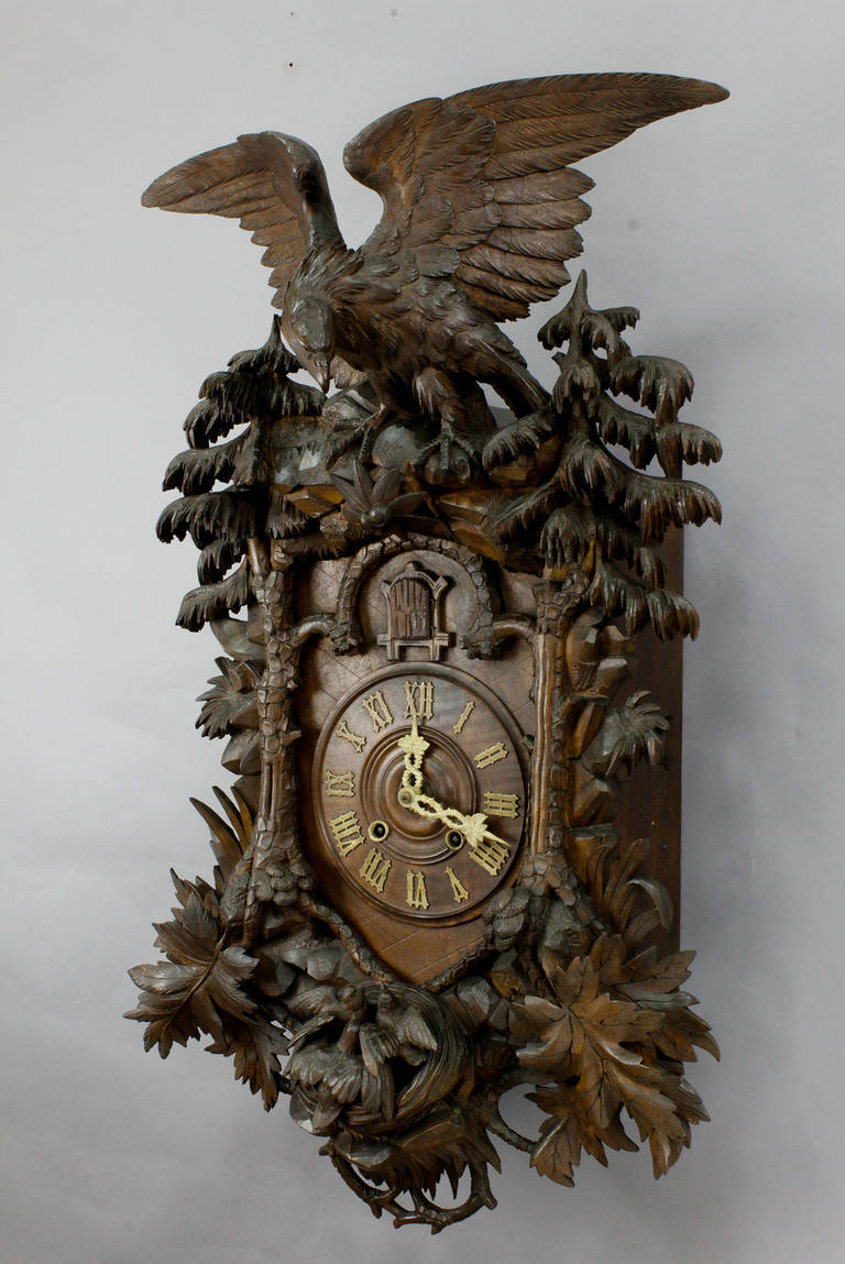 A very rare Black Forest cuckoo clock. Fine carved wooden case with eagle on a rock outcrop, bird's nest, trees and foliage. Clockwork in working order. A very rare original piece of Black Forest clock making.