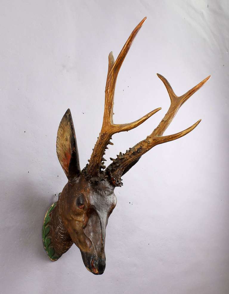 A hand-carved wooden roe deer head with a large Siberian deer trophy, executed circa 1800.