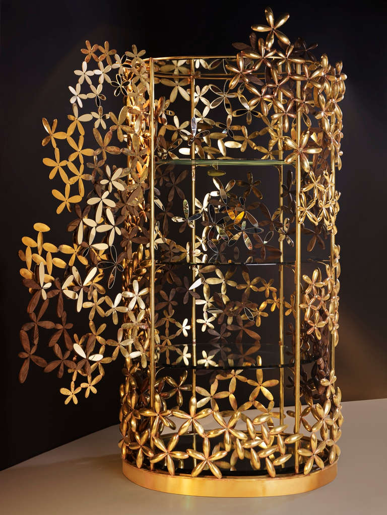 A bejeweled masterpiece of design and craftsmanship, ‘The Naïve’ embodies spring. She is light and golden yet simple in her dress of brass and wood flowers sculpted one by one. This exquisite handmade cabinet was created by Taher Chemirik, named by