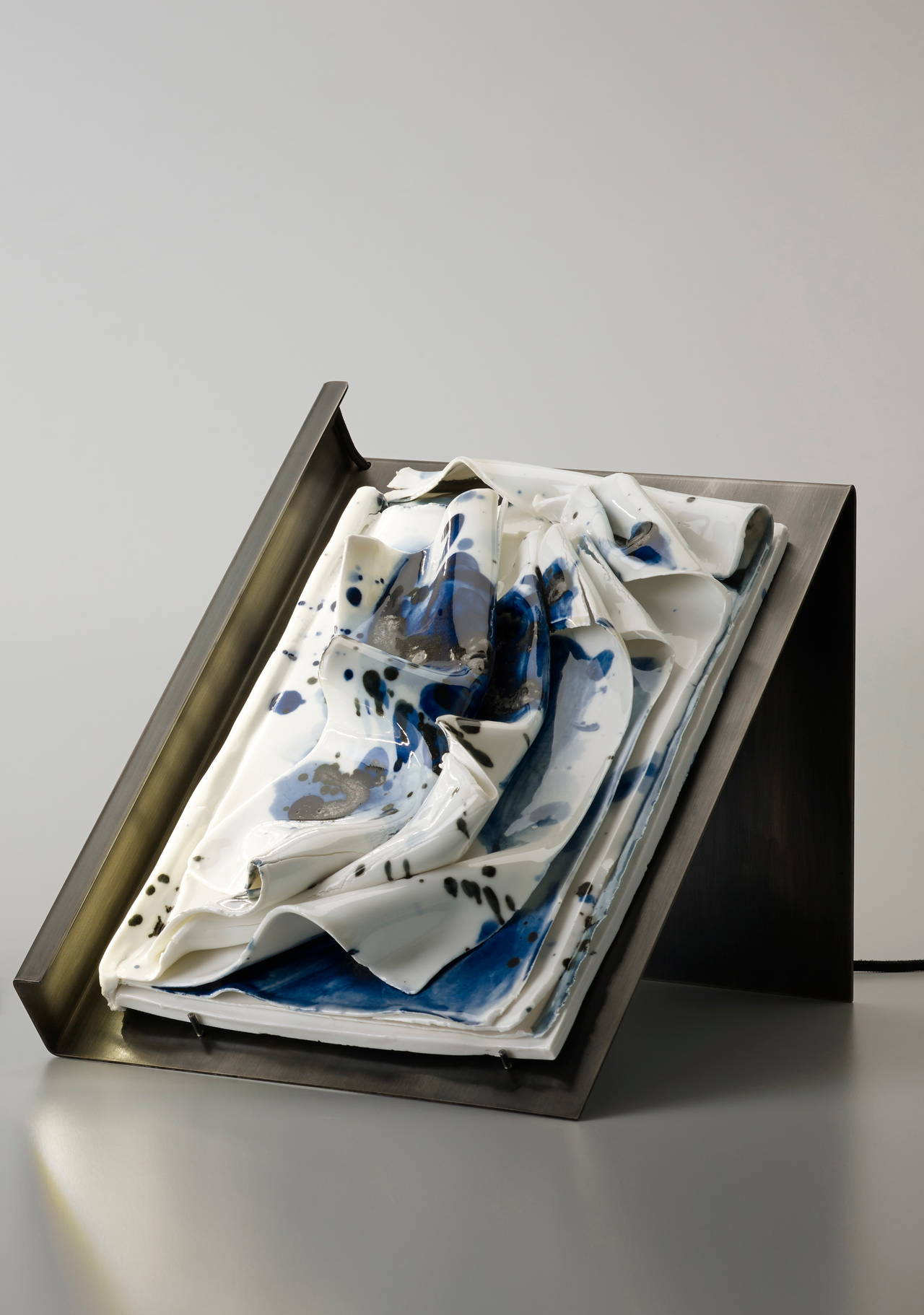 'Storm' is a unique handmade porcelain book and table light sculpture. It is part of the ‘Insomnio’ collection, a set of 21 striking porcelain books handmade by French visual artist Charlotte Cornaton, 28 years old, in the famous historic workshops