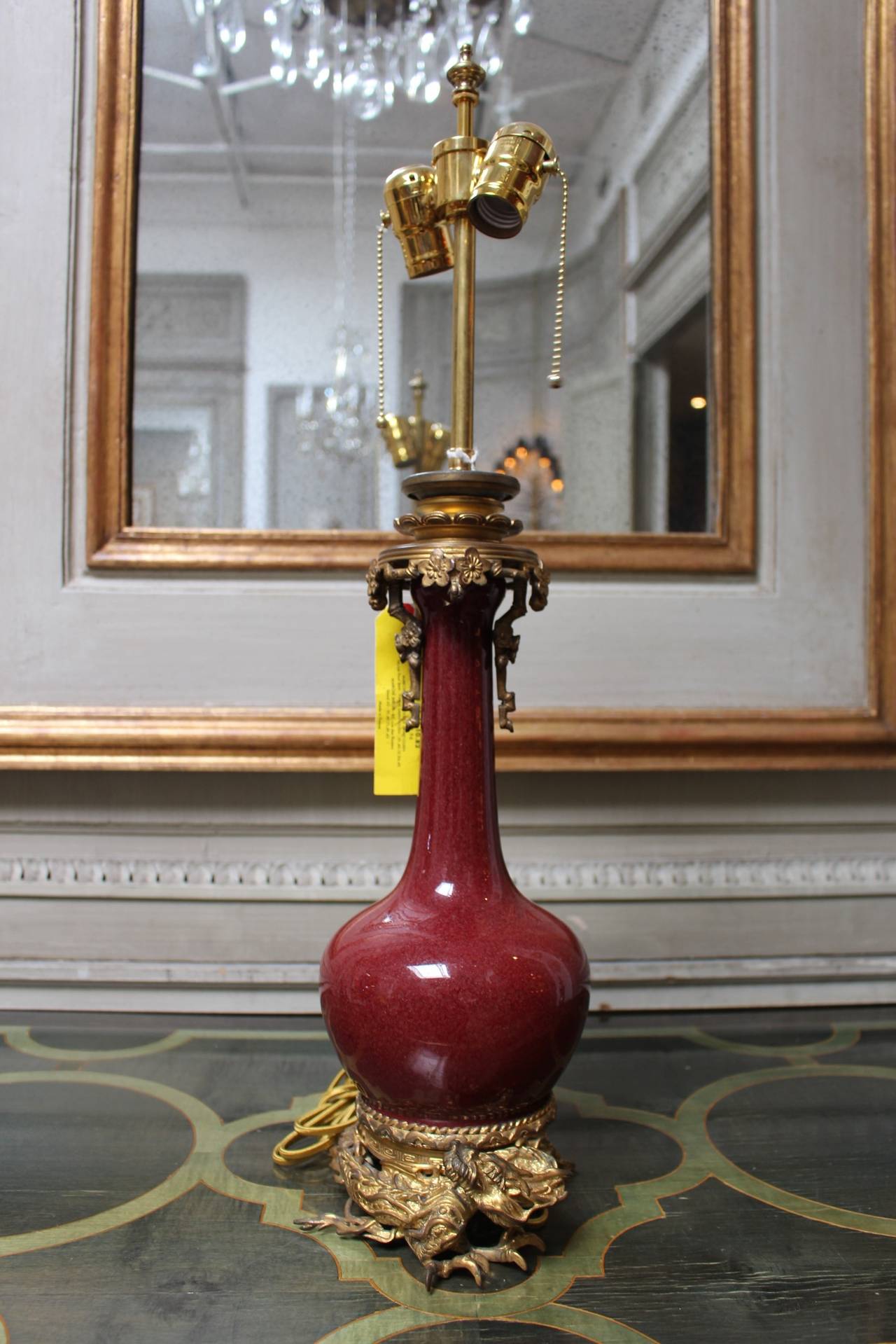 A Sang de Boeuf Table Lamp with Dragon Motif Ormolu Mounts