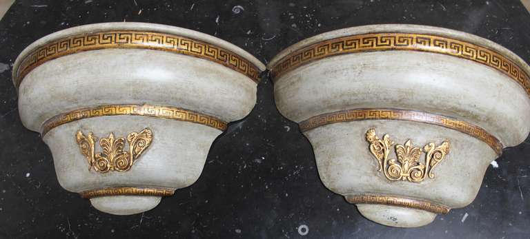 A pair of French 19th century painted and parcel-gilt tole wall jardinieres wired as wall sconces.