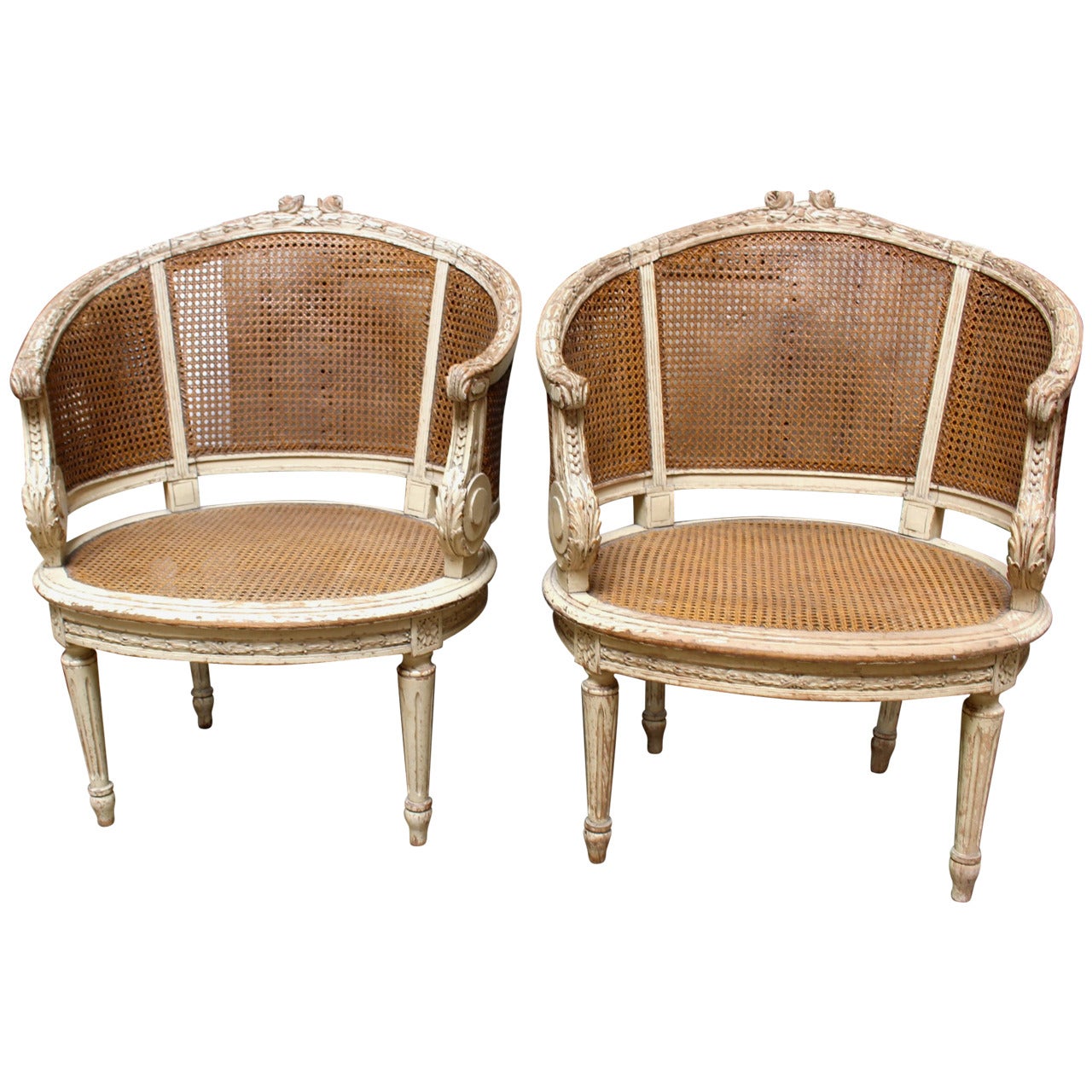 Pair of French Louis XVI Style Caned Bergeres in a Painted Finish