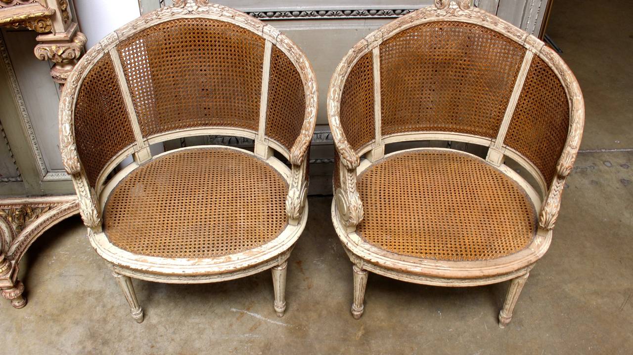 Pair of French Louis XVI Style Caned Bergeres in a Painted Finish