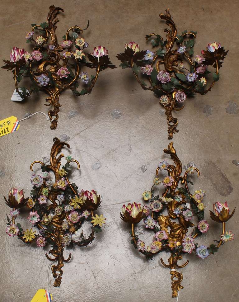 A Set of Four Louis XV Style Bronze Sconces with Porcelain Flowers and Leaves made out of Tole