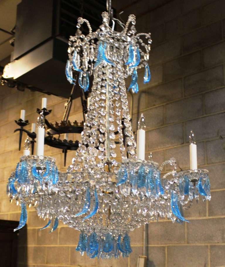 A French Directoire style iron and crystal chandelier with blue feather shaped crystals. This chandelier is very decorative and a nice scale.