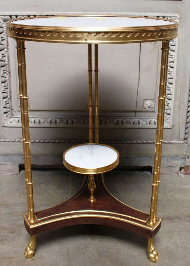 French Louis XVI style side table after a model by Adam Weisweiler with a white marble top.