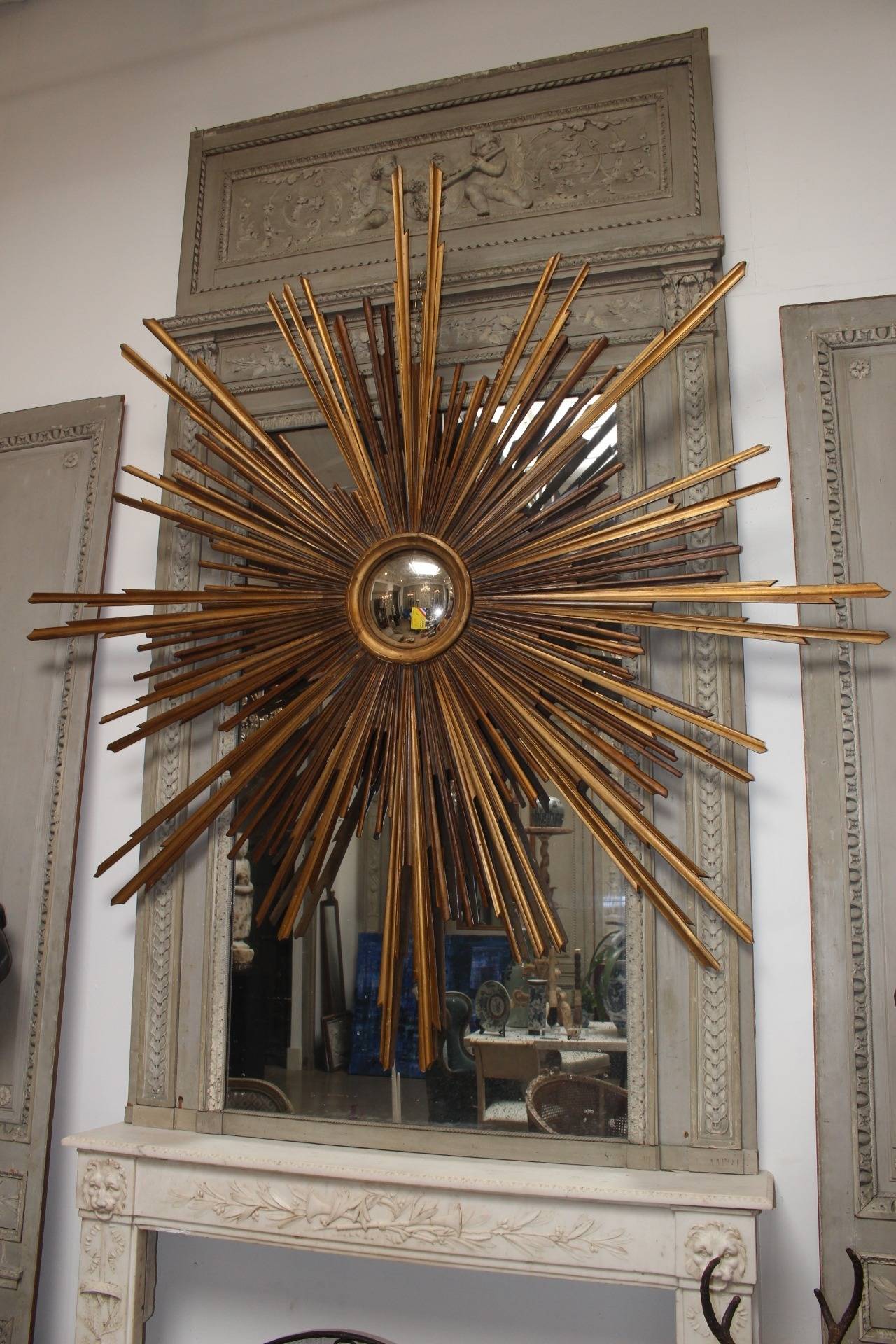 A monumental 19th century giltwood Italian sunburst mirror.