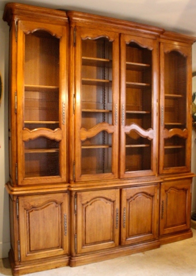 Large French Louis XV style oak bookcase with adjustable shelves and chicken wire in doors.