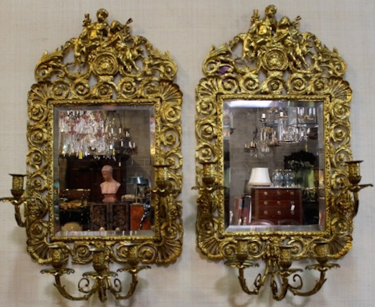 Pair of 19th century French Louis XVI style gilt bronze and mirrored five-arm wall sconces.