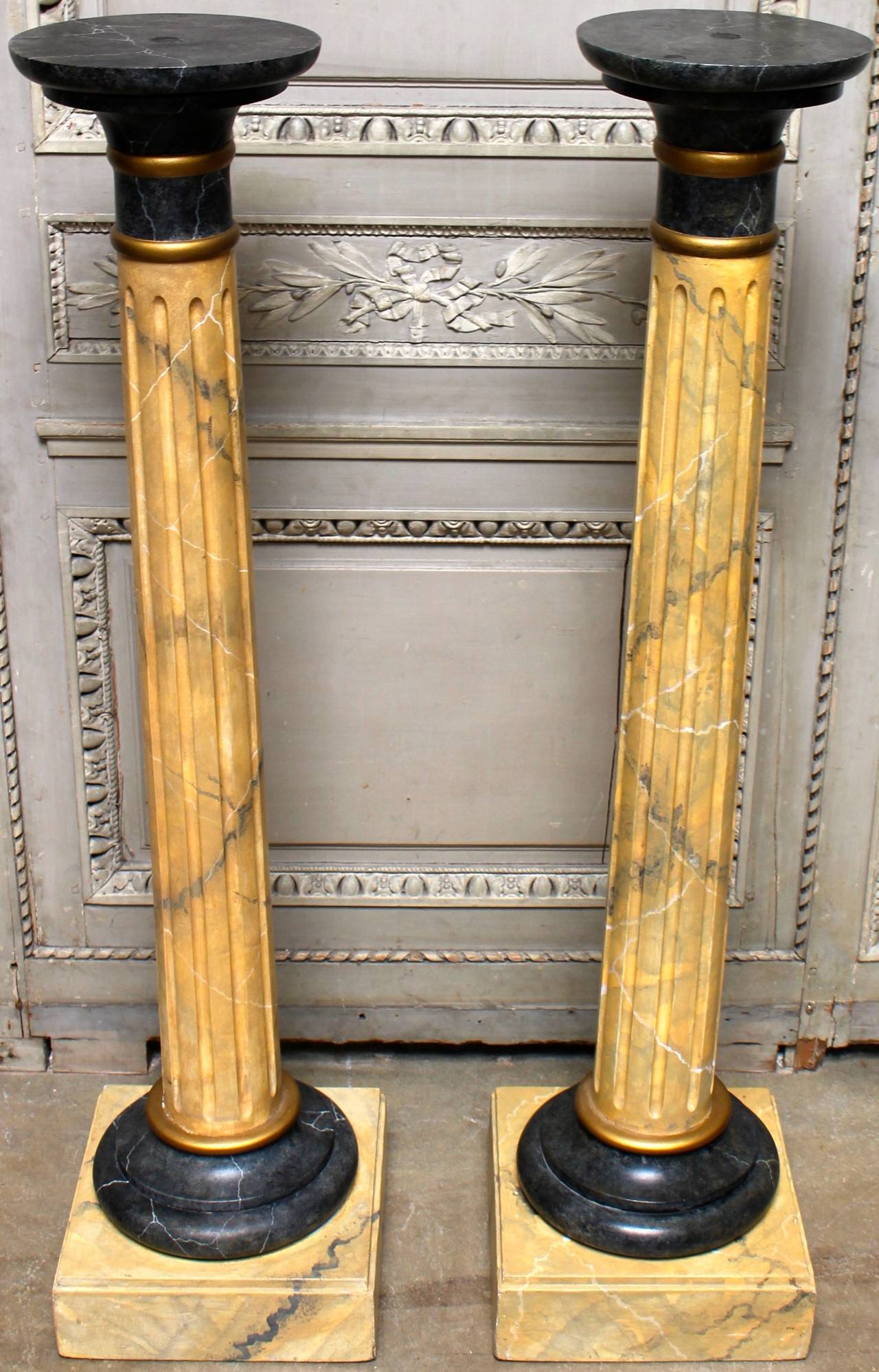 A pair of wood columns with faux marble painted finish.
