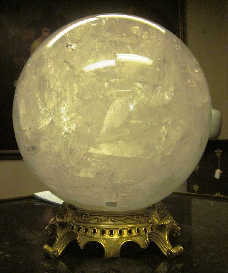 A large French rock crystal sphere on a bronze base.
Measures: 12