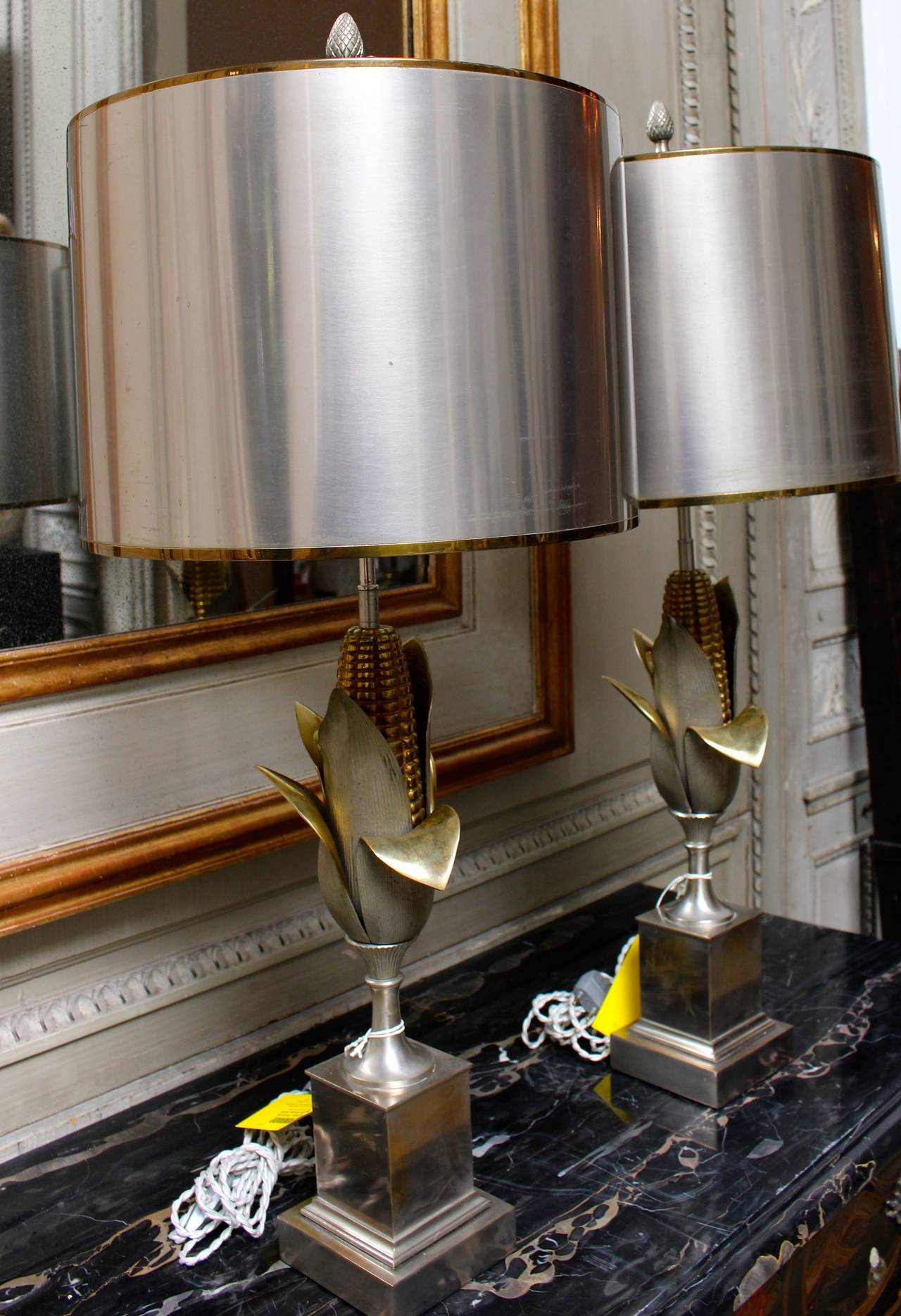 A Pair of Maison Charles Corn Lamps in steel and brass, with matching metal shades.  These lamps require new wiring.