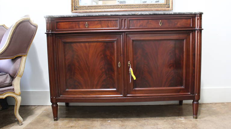 A French Louis XVI mahogany buffet with marble top.