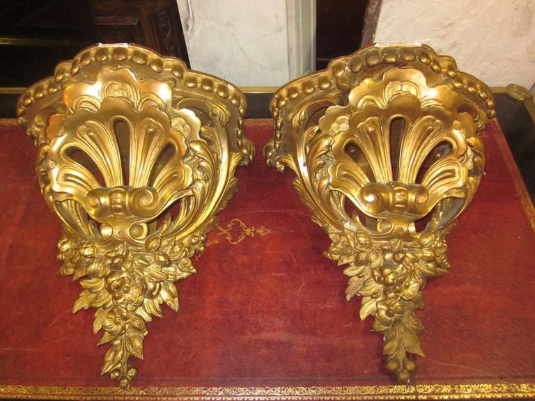 A pair of French 19th century gilded wood and plaster wall brackets.