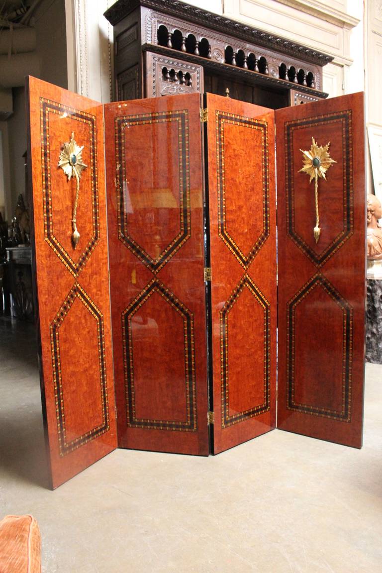 A continental four-panel, parquetry and bronze folding screen with inlaid exotic woods and bronze and marble Baroque style mountings.