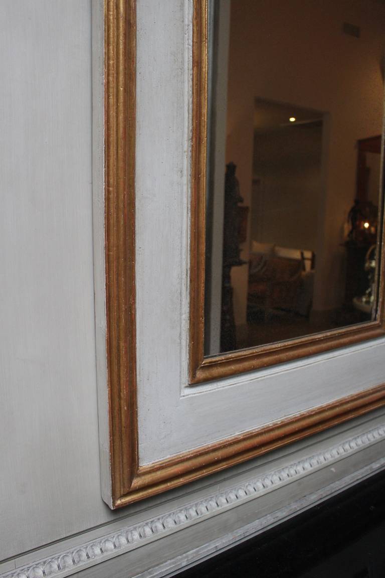 Wood Pair of French Regence Style Mirrors in a Gray Painted and Gilt Finish