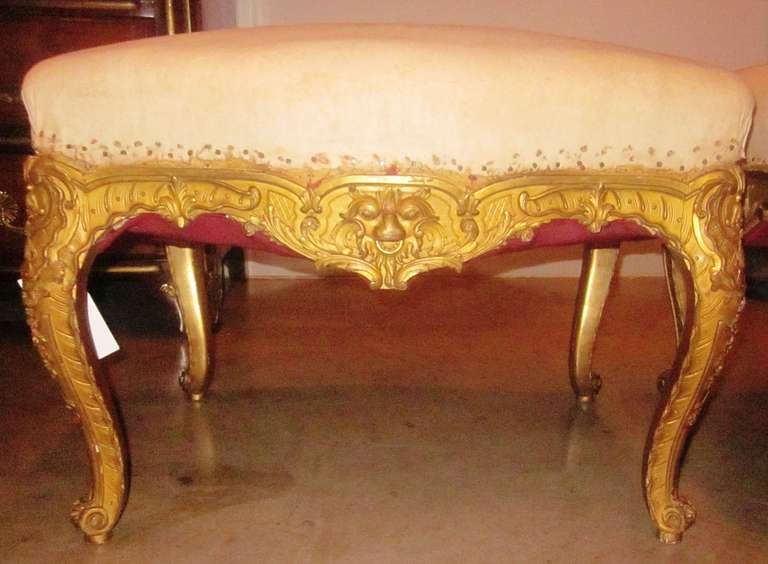A very fine pair of French Regence style carved giltwood tabourets. Presently needing reupholstery.