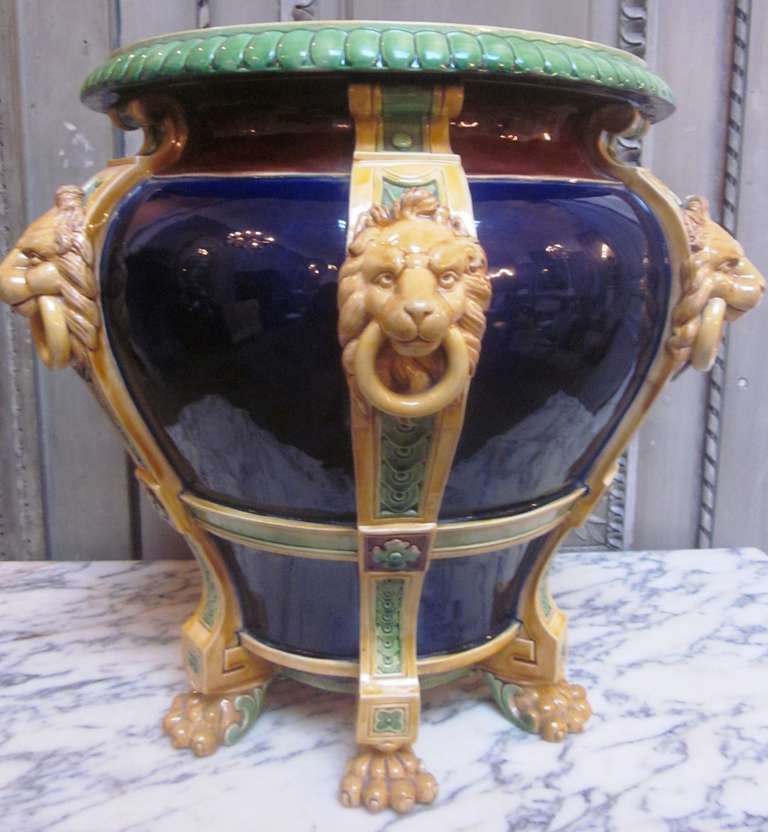 A 19th century Minton Majolica cobalt blue ground jardinière. The baluster shaped jardinière has six pilasters applied with lion mask and ring handles and stands on paw feet. 
It has the Minton factor mark and No # 1023 impressed on the bottom.
