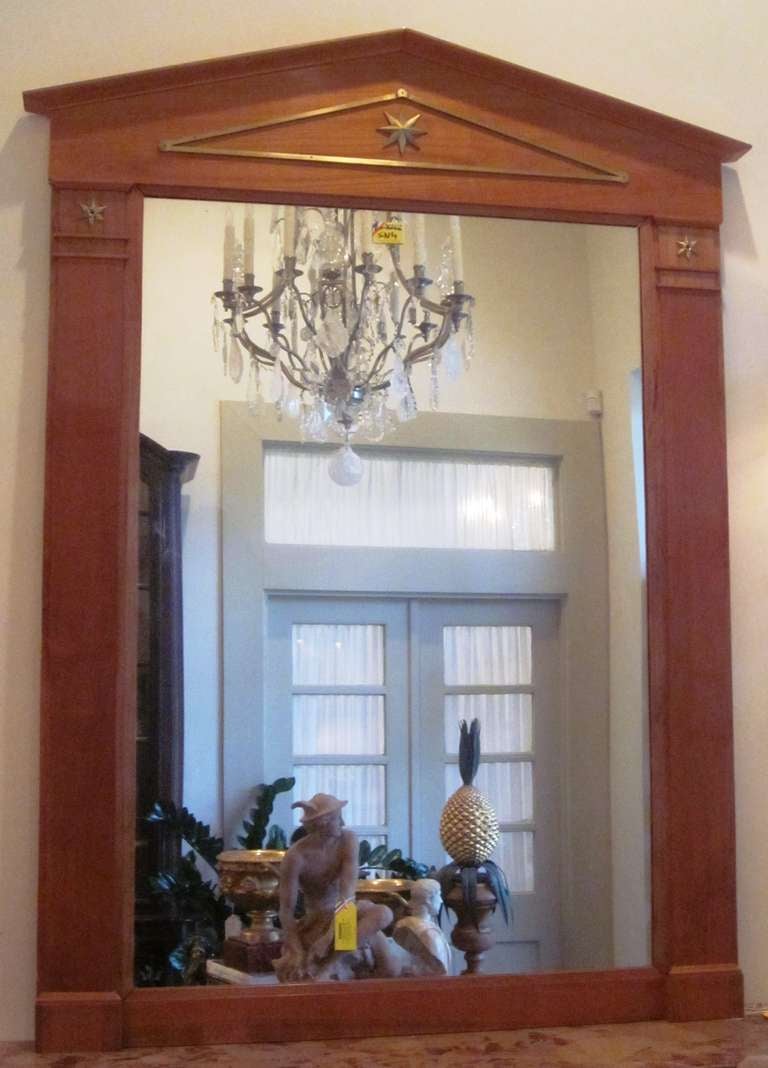 A French mahogany mirror with bronze mounts in the style of Andre Arbus.