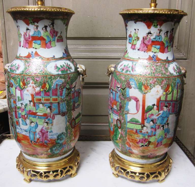 A pair of Chinese rose medallion porcelain lamps with a bronze dore base and cap. 19Th C\century, shades not included.