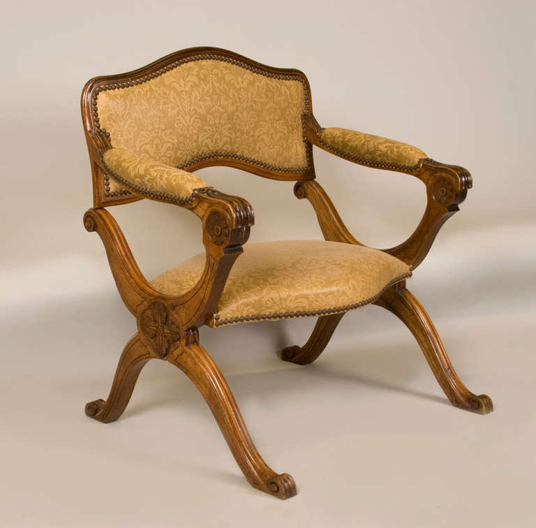 A unusual prie dieu  (prayer stool )  chair, early 19th century, Italian, with padded arms,hingeing forward on scrolled , shaped legs.
A padded leather seat is finished with nailhead trim.  
The upholstery material is  french gaufrage-