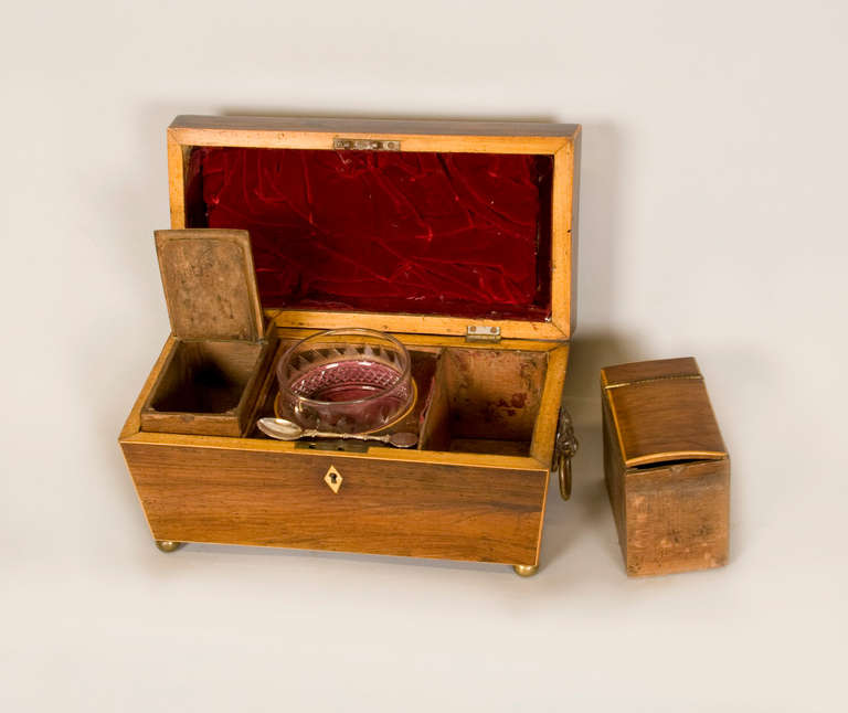 Fine English rosewood tea caddy with original cut crystal mixing glass.
Beautiful and rare mid-19th century classical form box, with both storage
liners in tact as well as the original mixing glass. The neoclassic form is outlined with satinwood