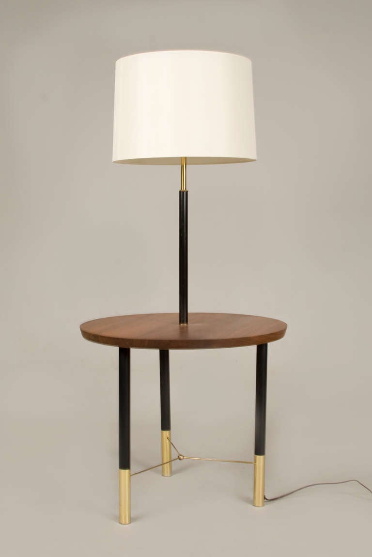 Elegant floor lamp with walnut center table. Over a tripod black enamel and brass legs and ball stretcher. Black enameled stem incorporates original acrylic and metal diffusers.

Drum shade not included in price of lamp.