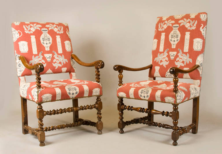 Two very similar Louis XIII period armchairs upholstered in Clarence House fabric. Extra fabric included. Slight wear to fabric, chairs upholstered in horse hair. 

Measures: Chair A: 40" H x 20" D x 24" W x 26" AH x 18"