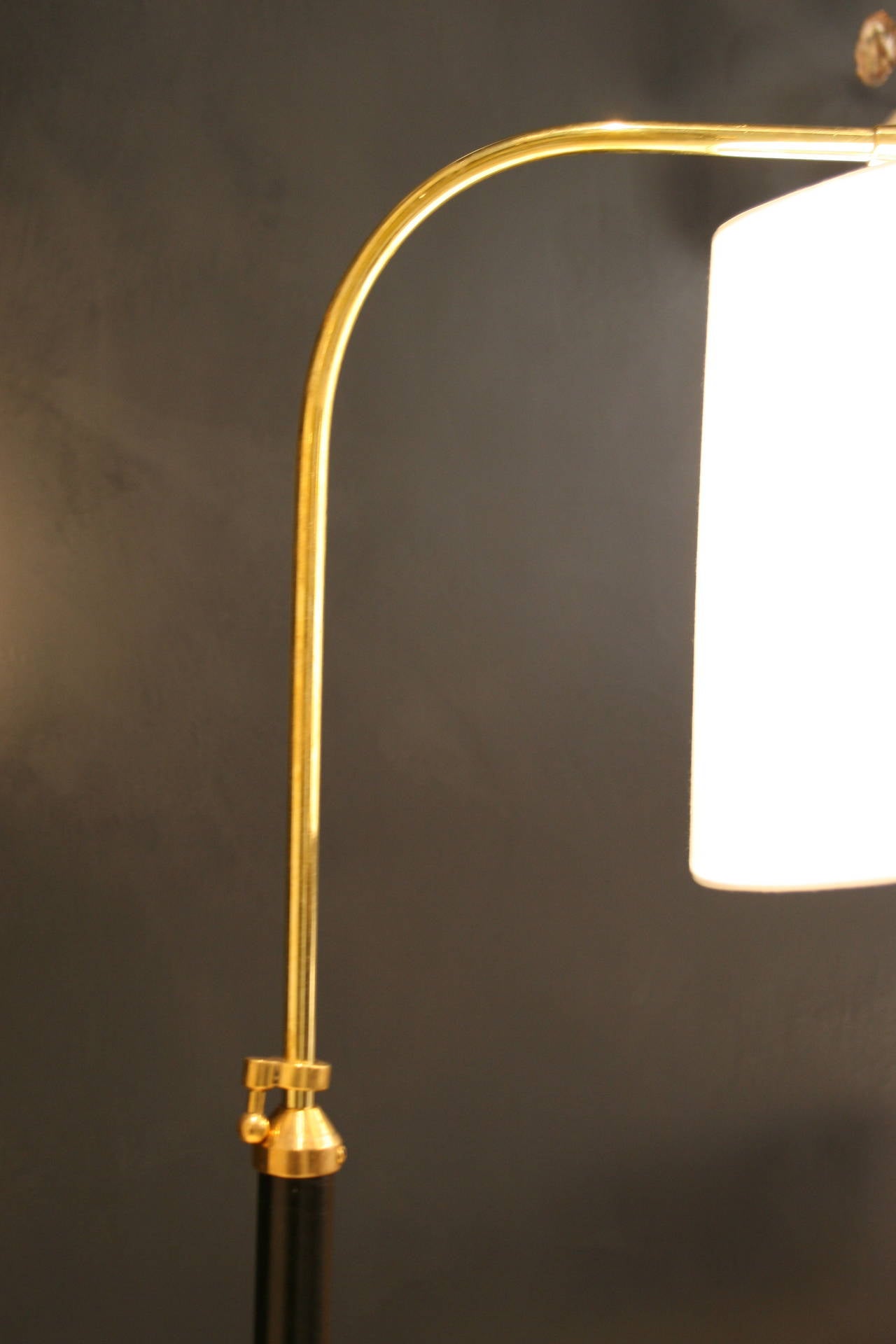 Hand-stitched leather and brass reading lamp by Jacques Adnet.
Silk Shade is fully articulating. Arched Brass arm swivels and 
extends to a height from 52