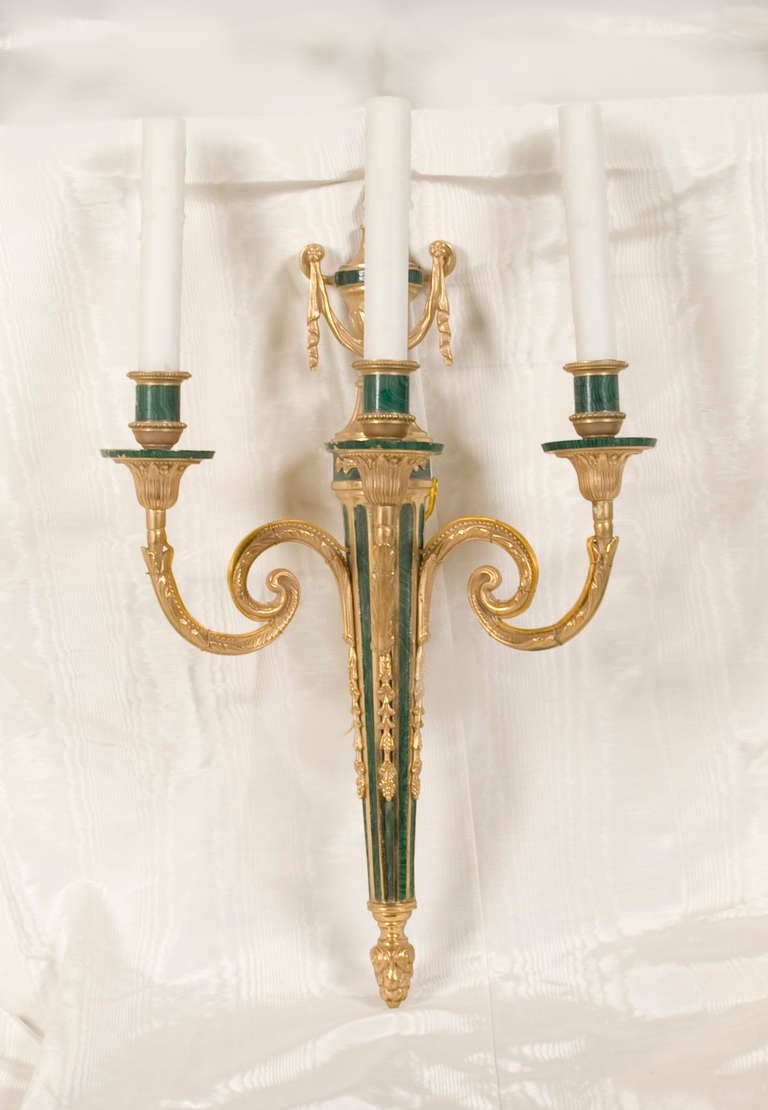 Louis XVI style, hand chased gilded bronze and malachite three-light sconces.