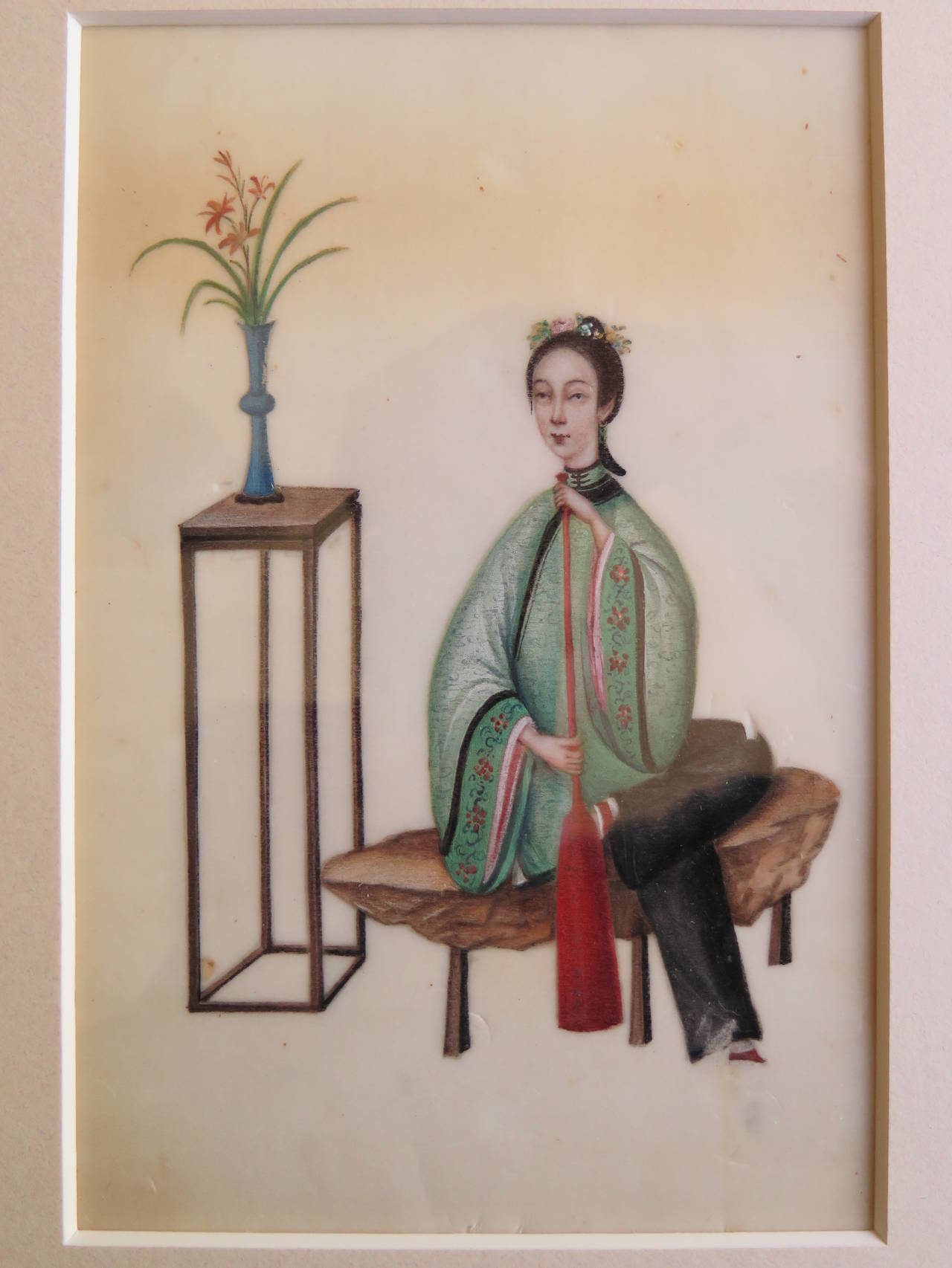 These are a beautifully painted pair of Chinese water-colours from the early 19th century, circa 1830

Both paintings depict ladies in a seated position playing musical instruments sat by tables holding flower vases. The ladies have very slim