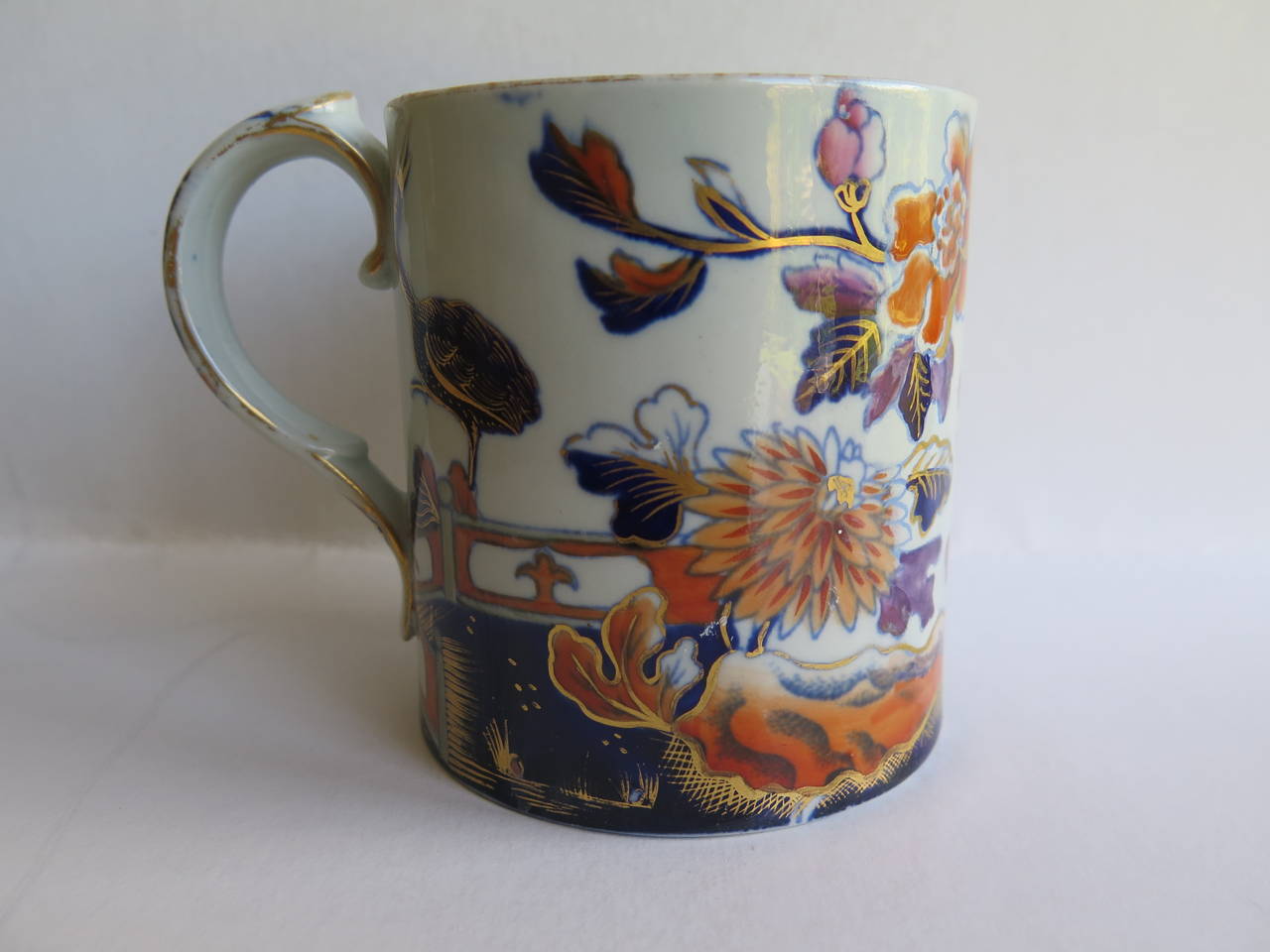 This is a rare and early Stone China  (Ironstone) MUG which dates to the George 111 period, c.1815. made by the DAVENPORT factory of Longport, Staffordshire Potteries, England.

The mug is straight sided similar to a coffee can and has a loop