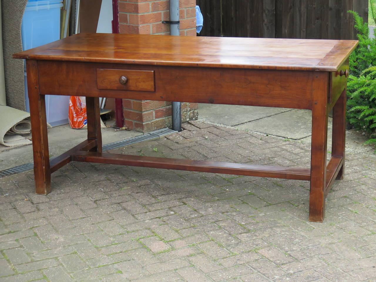 This is a superb French Refectory / Farmhouse / Dining Table.

The table is made of solid Fruitwood, probably Cherry wood. It is of pegged construction with four planks to the top, cleated either end. The freeze has a drawer on either long side