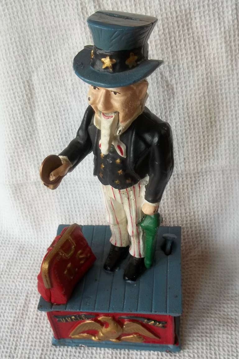 This is a North American MONEY BOX Toy, made from Cast Iron and then Hand Painted. 

This is a working toy money box, where a coin is placed in the open hand of Uncle Sam and pressing the lever down,  ( as shown in the photo with the yellow
