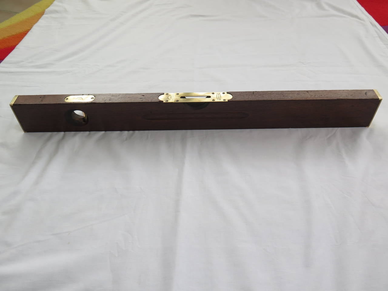 This is a very good quality architects or builders spirit level by the well established firm of J. Rabone & Sons, Birmingham, England.

At 30 inches long, this was one of their longer spirit levels at the time and has a solid mahogany frame with
