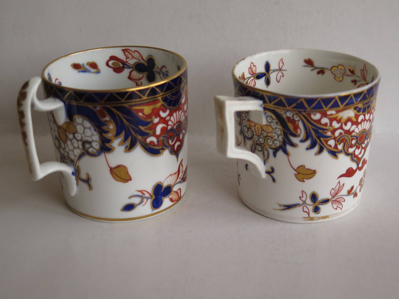 This is a finely painted, similar pair of porcelain coffee cans made by the Derby factory, England,  in the reign of George 111 in the early 19th century, circa 1810
 
Straight sided coffee cans were only made for about the first 20 years of the