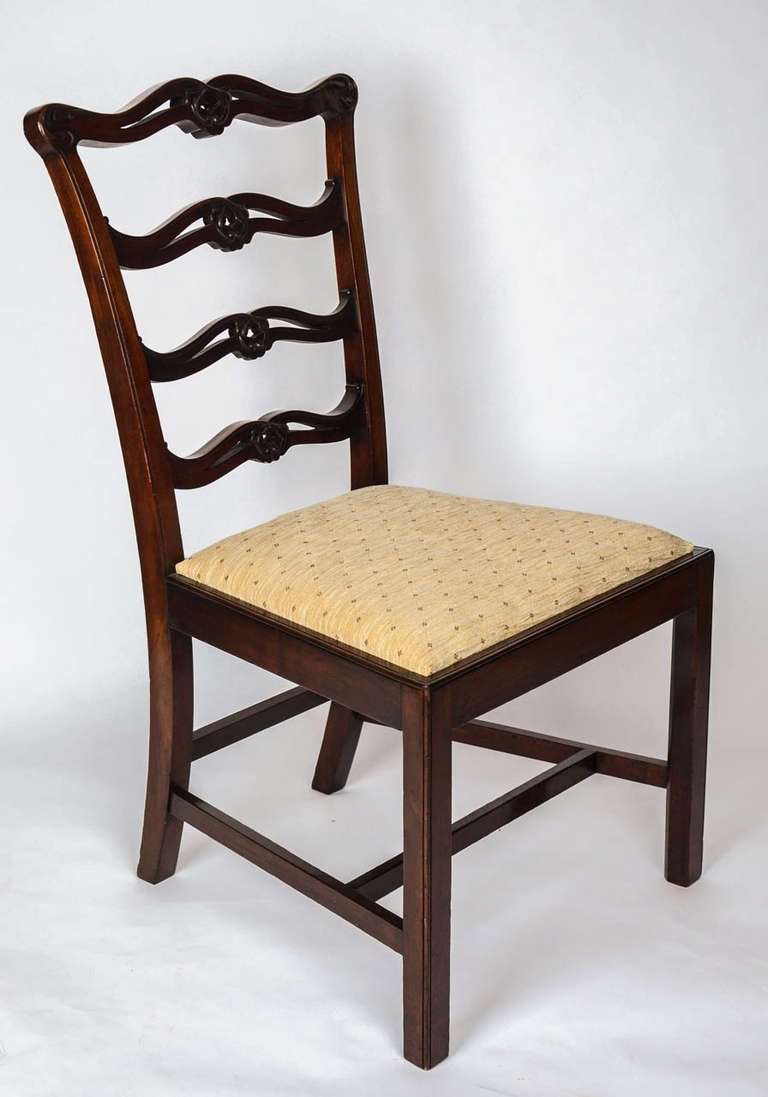 A superb pair of mahogany, ribbon back, side or dining chairs carrying the ivorine plaque of S and H Jewell, High Holborn, London, WC1.

The chairs have a ladder or Ribbon-Back splat which has fine crisply hand- carved detail, with square legs