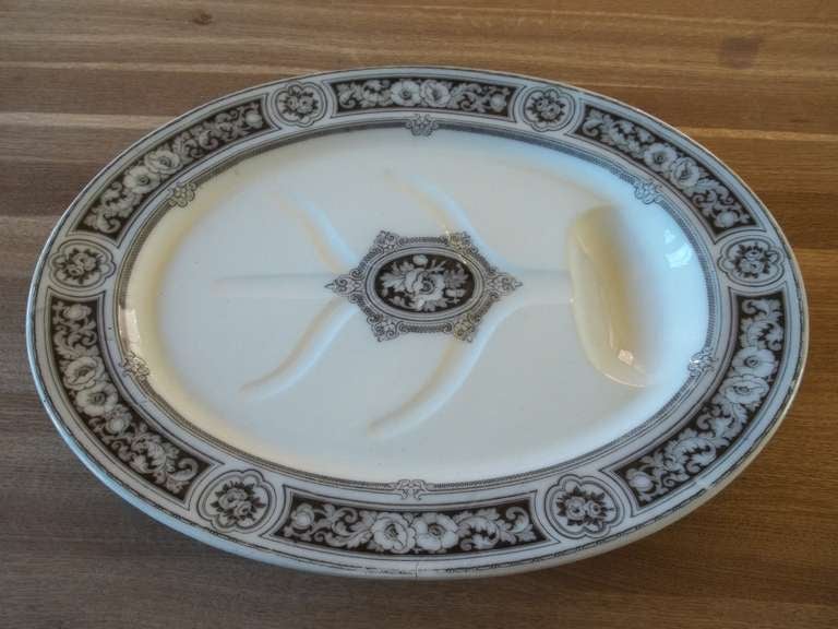 This is a VERY LARGE and HEAVY Oval MEAT Serving  PLATTER, manufactured of Ironstone Pottery. The platter has a shaped gravy well within it, where the meat juices can drain.

The base is also shaped to form a raised oval foot section, which makes
