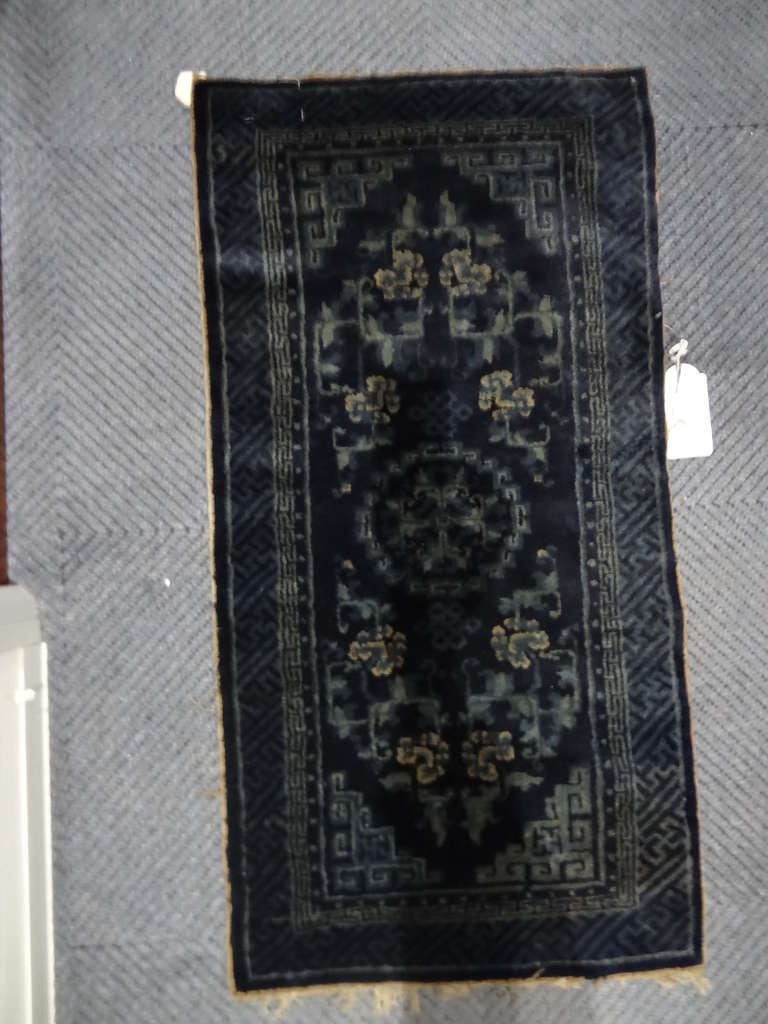 Chinese OPao Tao Rug,with dark and pale blue foliate motifs in the field,with a narrow fretwork outer border. 

Dimensions: 

118 cm. x 64 cm. 

Provenance Chatsworth House Attic Sale

  Unmarked, except for provenance proof.