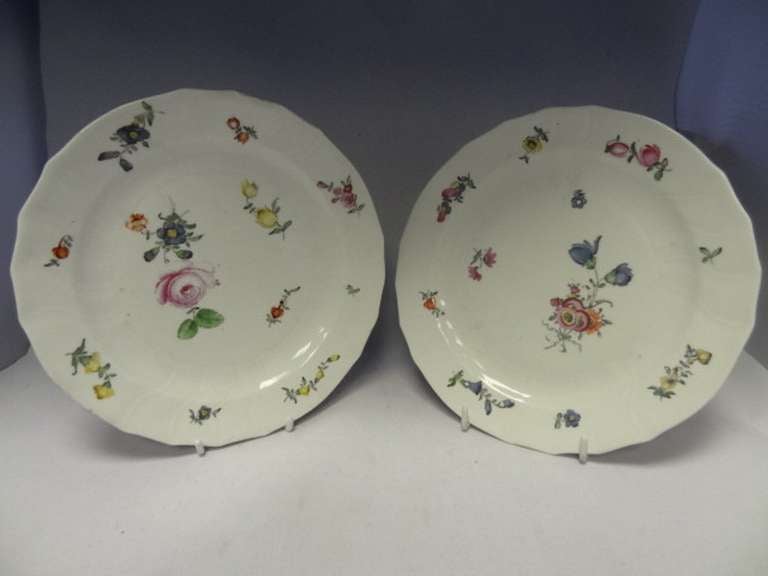 Porcelain plates moulded in the Tournai Form with the slight scalloping (per ^Unterberg, p 274 plate 451), the decoration of sprigs on flowers to the edges and the central panel may be by Geisler. 

Plates' diameters each 22.00 cm. 

Literature: