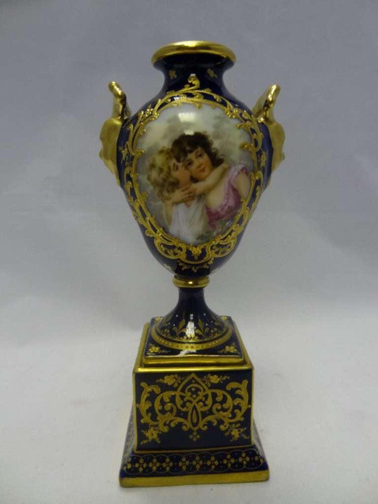 Porcelain Vienna vase with two delightful and exquisitely decorated cartouches of pairs of children depicted. The rich gilding is typical of Vienna of that age together with the rich cobalt blue background. One panel is signed Hurrer. The