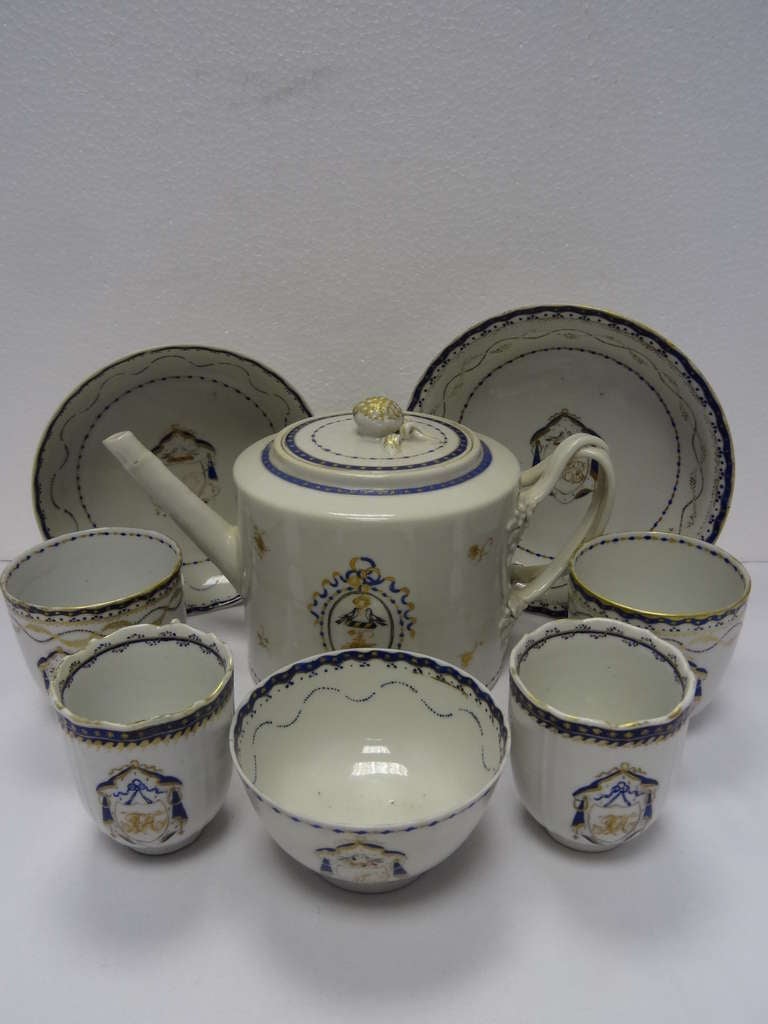 A Chinese armorial ware part tea set comprising : teapot with crossed handles, a trio of saucer and two cups and another the same. There is some slight variation in the cups and saucers. 

CHINA TRADE (18th Century)