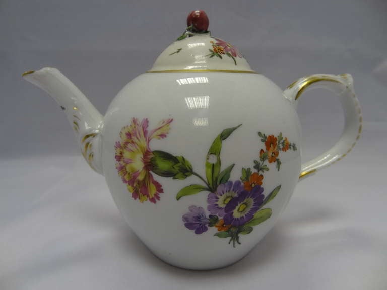 Porcelain teapot,the body of which is the inverted pear shape with a short spout moulded with foliage and foliated loop handle. Domed cover with flower bud knop. 

Signed/Inscribed/Dated; Berlin KPM sceptre mark used between 1763 -