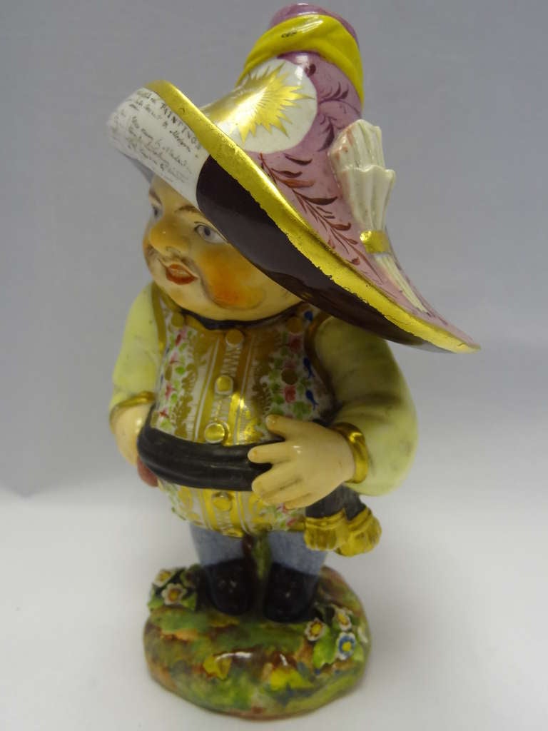 Mansion House Dwarf,one of a series created by Robert Bloor. This rather corpulent example has an auction notice 'Auction of Valuable Paintings' attached to the brim of the hat,a feature of later figures,together with the bolder colours. 

It