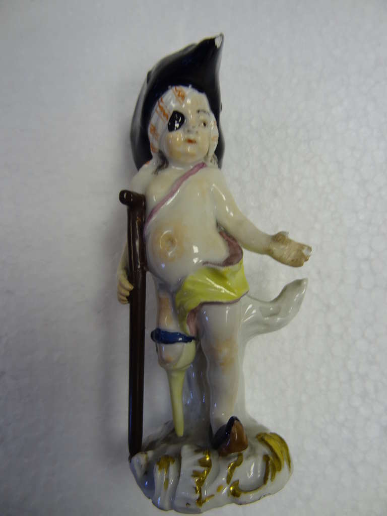 Kaendler produced a number of Cupid in Disguise figures.  This beautifully modelled figure, with his comically oversized tricorne hat, is Cupid disguised as a Pirate.  He has a wooden leg and leans upon a crutch for support.

The relatively small