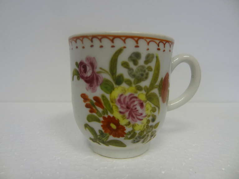 A fine example of a Bow coffee cup, a slightly everted rim, the arcaded border and the vibrantly coloured floral decorations to the exterior.
