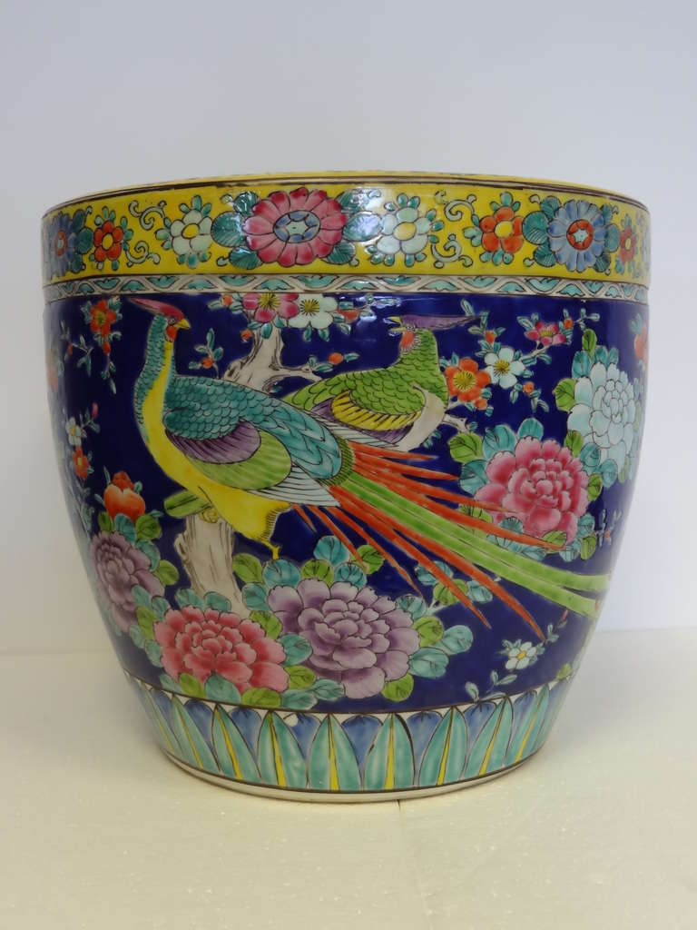 A very handsome jardiniere, decorated with exotic birds amongst rocks and flowers.