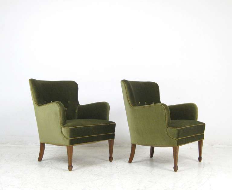 This pair of Frits Henningsen armchairs is upholstered in possibly the original green velvet. With mahogany profiled legs and traditionally sprung seats. Reception chairs from the cabinet maker for whom it was all about quality.