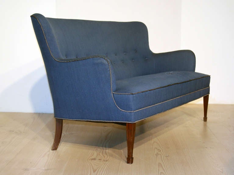 This sofa was made in Denmark by cabinetmaker Frits Henningsen circa 1930-50. The original blue wool fabric is well worn with a one minor loss as shown in picture.  This sofa is 156cm wide.

Reupholstery available on request for additional